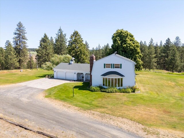 1616 N Ritchey Rd, Reardan, WA 99029 - view of front of house featuring dirt driveway, a garage, a front yard, and a chimney