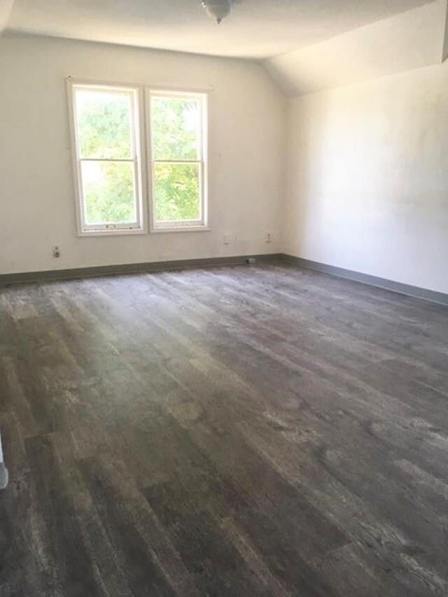 1304 W Maxwell Ave, Spokane, WA 99201 - empty room featuring dark wood finished floors and vaulted ceiling