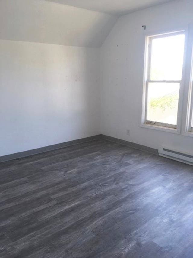 1304 W Maxwell Ave, Spokane, WA 99201 - additional living space with vaulted ceiling, dark wood-style floors, and baseboard heating