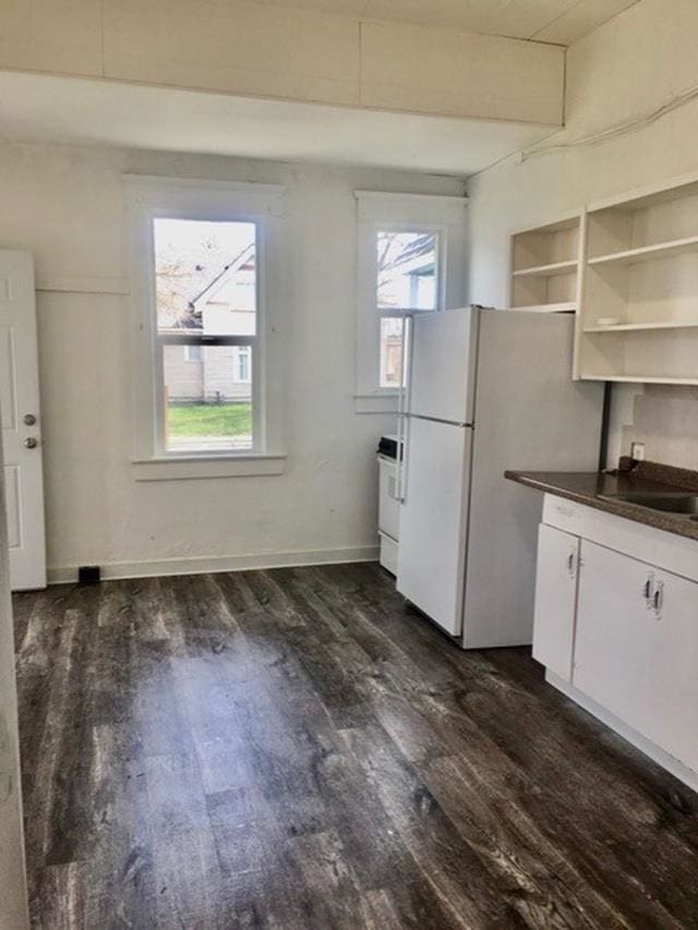 1304 W Maxwell Ave, Spokane, WA 99201 - kitchen with dark countertops, freestanding refrigerator, plenty of natural light, and dark wood-type flooring