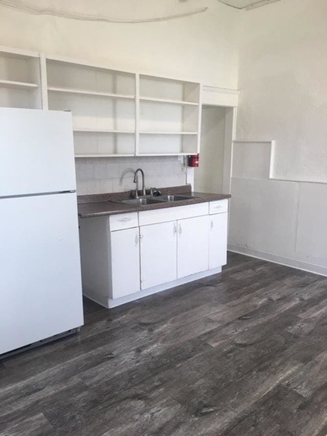 1304 W Maxwell Ave, Spokane, WA 99201 - kitchen with freestanding refrigerator, open shelves, dark countertops, and dark wood-style flooring