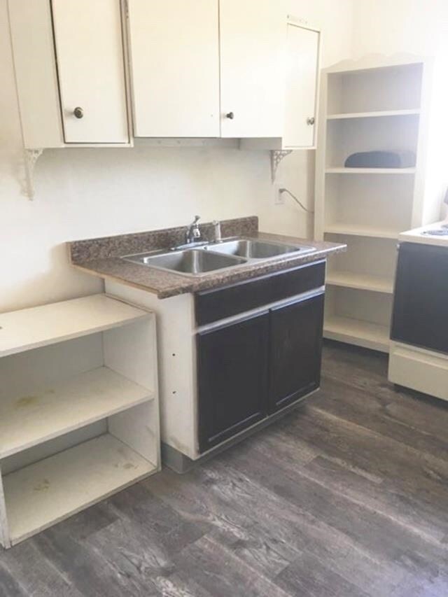 1304 W Maxwell Ave, Spokane, WA 99201 - kitchen featuring dark wood-type flooring, white cabinetry, stove, and open shelves
