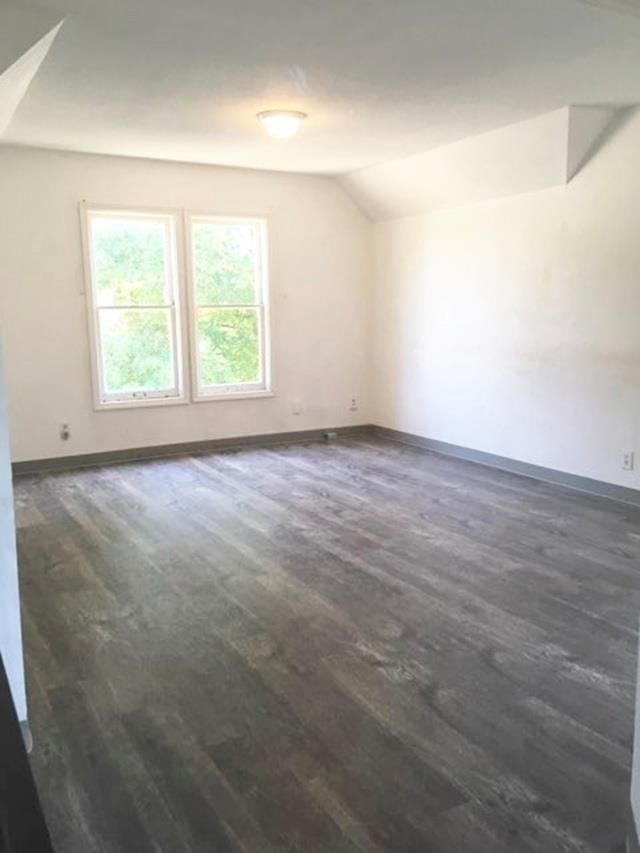 1304 W Maxwell Ave, Spokane, WA 99201 - empty room with vaulted ceiling and dark wood-type flooring