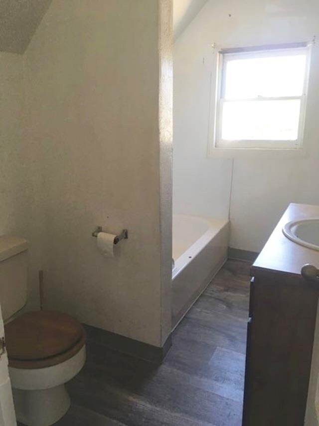 1304 W Maxwell Ave, Spokane, WA 99201 - full bathroom featuring vanity, wood finished floors, and a bathtub