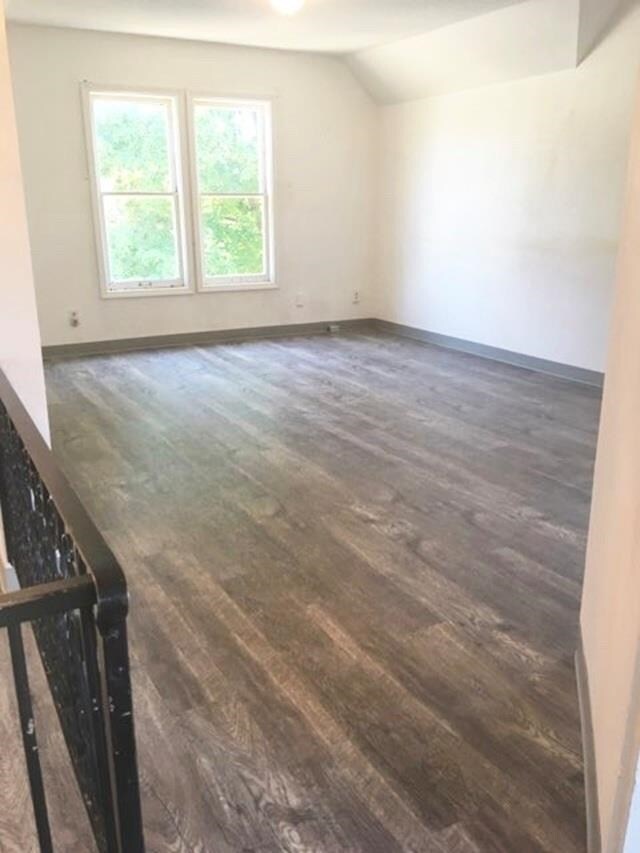 1304 W Maxwell Ave, Spokane, WA 99201 - spare room featuring dark wood-type flooring and vaulted ceiling