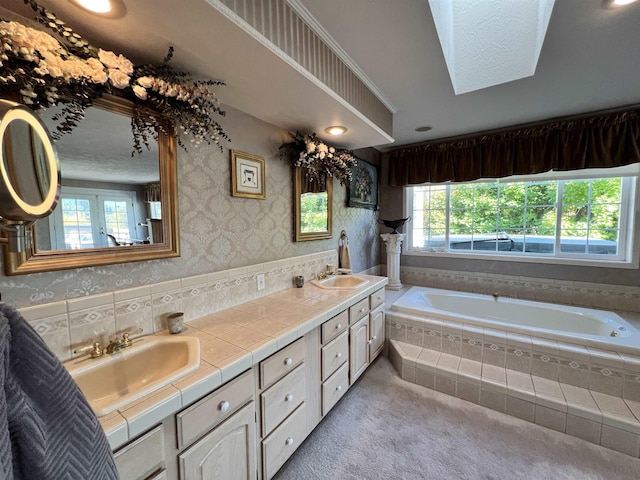 1703 W 25th Ave, Spokane, WA 99224 - bathroom featuring plenty of natural light, a bath, wallpapered walls, and double vanity