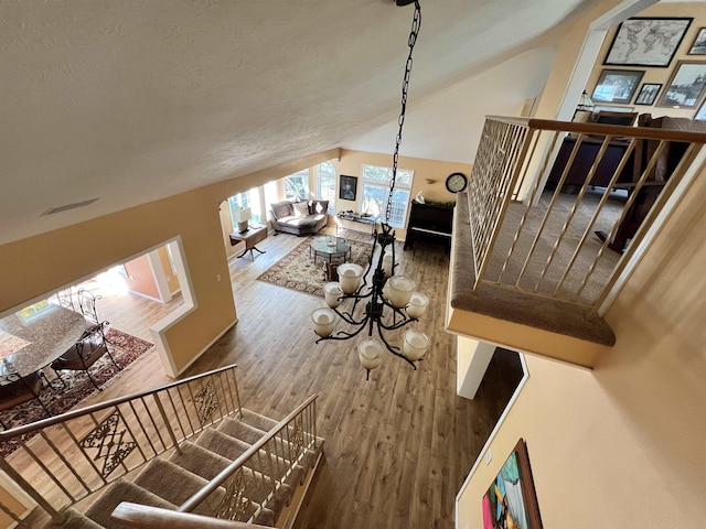 1703 W 25th Ave, Spokane, WA 99224 - stairway with wood finished floors, high vaulted ceiling, and a chandelier