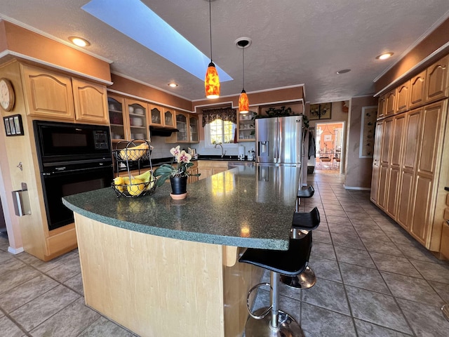 1703 W 25th Ave, Spokane, WA 99224 - kitchen featuring black appliances, crown molding, glass insert cabinets, a kitchen breakfast bar, and a kitchen island