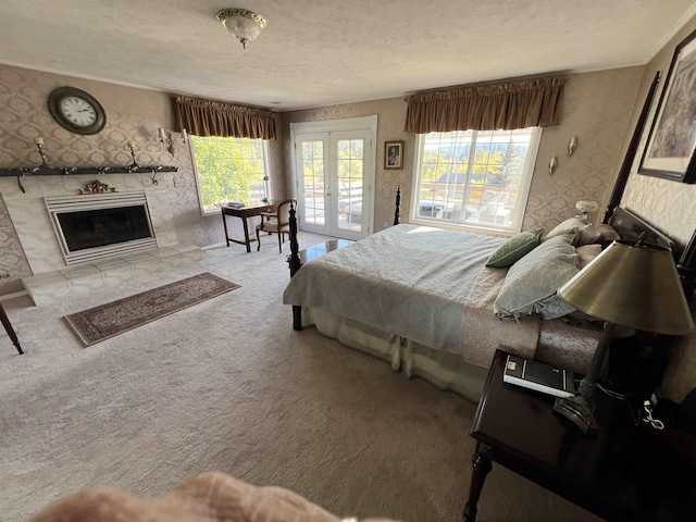 1703 W 25th Ave, Spokane, WA 99224 - carpeted bedroom with access to exterior, wallpapered walls, french doors, a textured ceiling, and a tiled fireplace