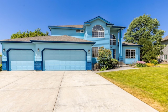 706 S Shelley Lake Ln, Veradale, WA 99037 - traditional-style house featuring a garage, driveway, a front yard, roof with shingles, and brick siding