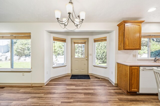 706 S Shelley Lake Ln, Veradale, WA 99037 - kitchen with white fridge with ice dispenser, arched walkways, a chandelier, light countertops, and brown cabinetry