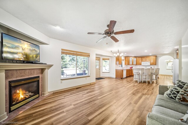 706 S Shelley Lake Ln, Veradale, WA 99037 - living area featuring a tiled fireplace, wood finished floors, and ceiling fan