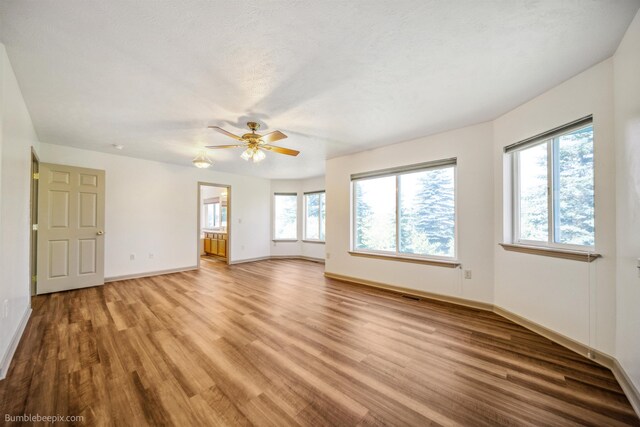 706 S Shelley Lake Ln, Veradale, WA 99037 - empty room with wood finished floors and ceiling fan