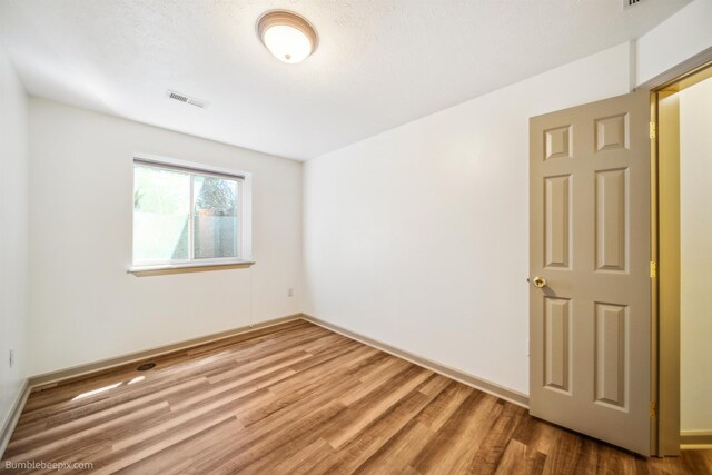 706 S Shelley Lake Ln, Veradale, WA 99037 - spare room featuring electric panel, track lighting, and wood finished floors