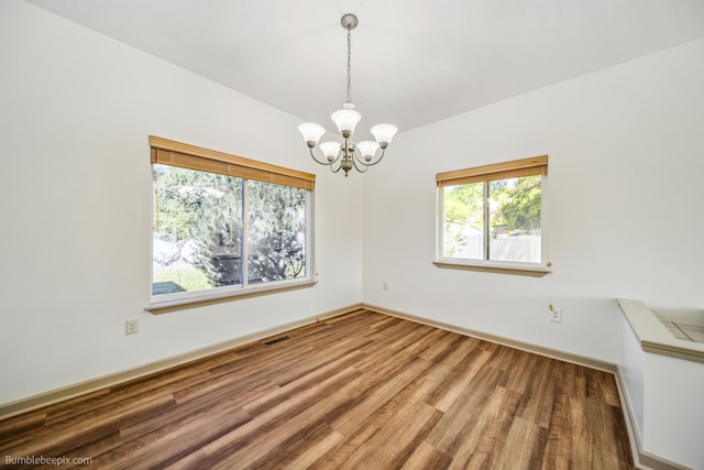 706 S Shelley Lake Ln, Veradale, WA 99037 - spare room featuring a chandelier, wood finished floors, and lofted ceiling