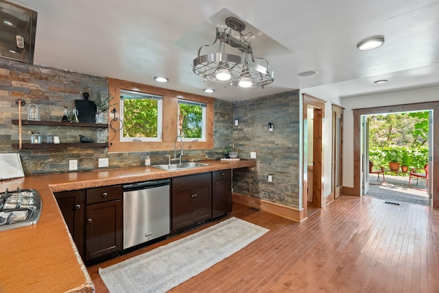 1420 W Main Ave, Spokane, WA 99201 - kitchen featuring appliances with stainless steel finishes, plenty of natural light, dark brown cabinetry, and light wood-style floors