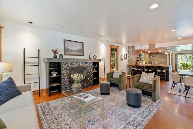 1420 W Main Ave, Spokane, WA 99201 - living room featuring a tiled fireplace, wood finished floors, and recessed lighting