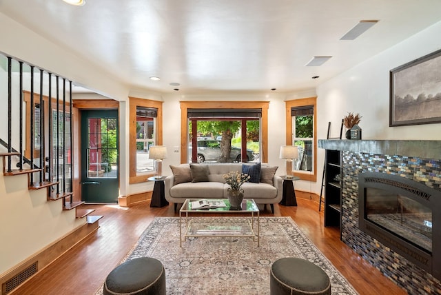 1420 W Main Ave, Spokane, WA 99201 - living room featuring wood finished floors, a tile fireplace, recessed lighting, and stairway