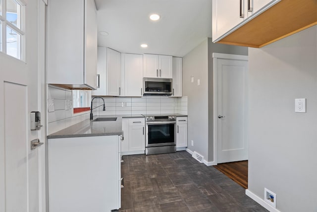 3218 E 24th Ave, Spokane, WA 99223 - kitchen featuring stainless steel appliances, recessed lighting, tasteful backsplash, white cabinets, and stone countertops