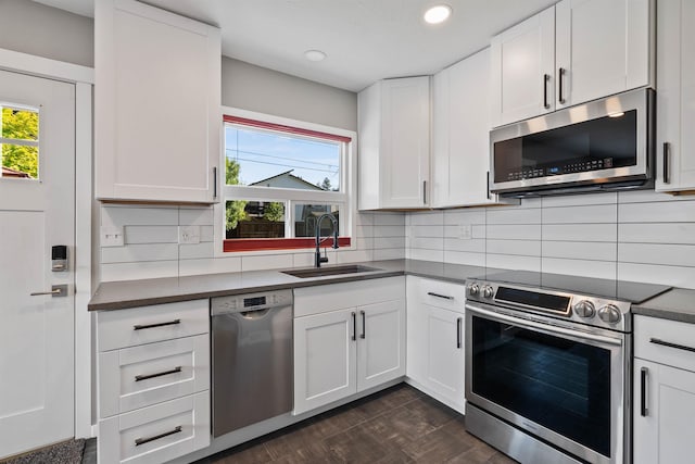 3218 E 24th Ave, Spokane, WA 99223 - kitchen with appliances with stainless steel finishes, dark countertops, white cabinetry, backsplash, and recessed lighting