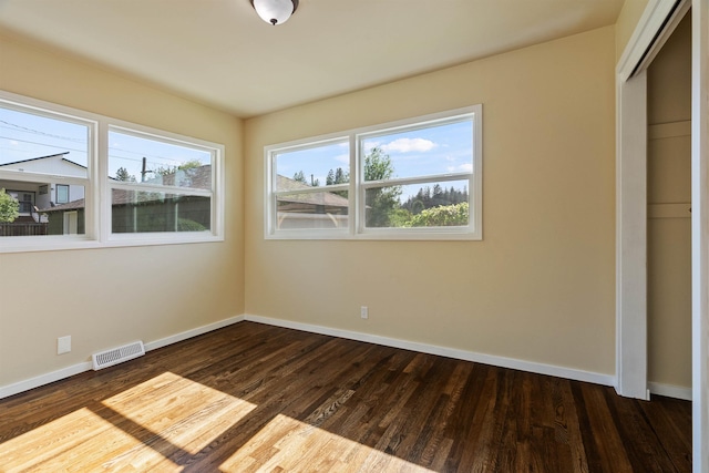3218 E 24th Ave, Spokane, WA 99223 - unfurnished bedroom with baseboards and dark wood finished floors