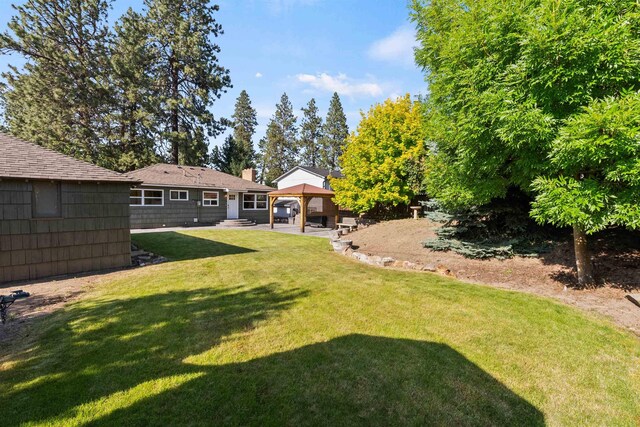 3218 E 24th Ave, Spokane, WA 99223 - view of grassy yard featuring a gazebo and a patio