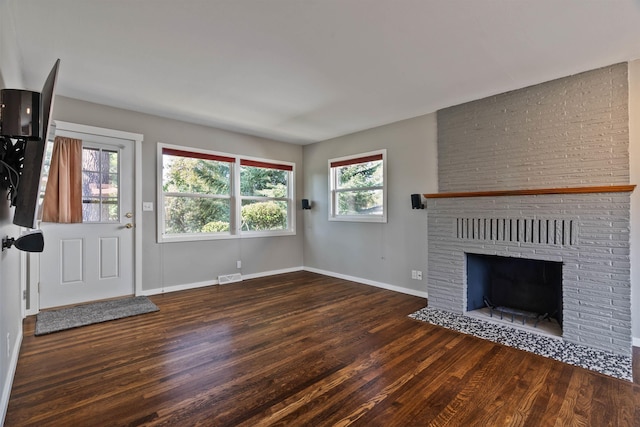 3218 E 24th Ave, Spokane, WA 99223 - unfurnished living room with wood finished floors and a brick fireplace