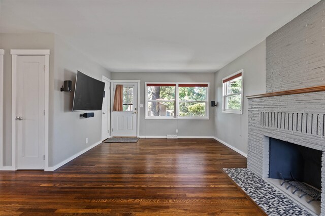 3218 E 24th Ave, Spokane, WA 99223 - unfurnished living room with wood finished floors and a brick fireplace