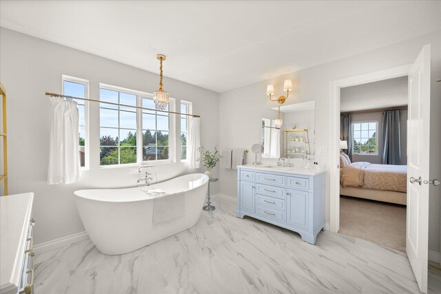 4620 E 43rd Ave, Spokane, WA 99223 - bathroom with vanity, marble finish floors, a freestanding tub, a chandelier, and ensuite bath