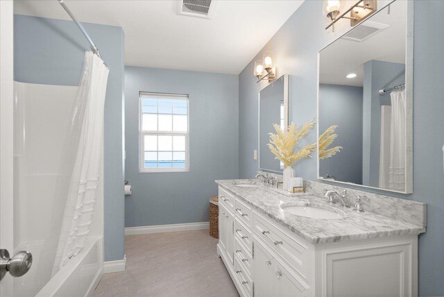 4620 E 43rd Ave, Spokane, WA 99223 - bathroom featuring double vanity and shower / bathtub combination with curtain