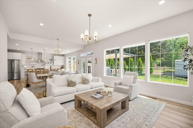 4620 E 43rd Ave, Spokane, WA 99223 - living room featuring a chandelier, recessed lighting, healthy amount of natural light, and light wood-style flooring