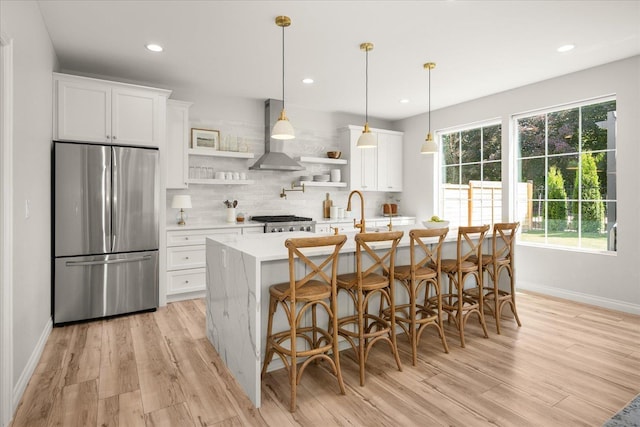 4620 E 43rd Ave, Spokane, WA 99223 - kitchen featuring freestanding refrigerator, open shelves, wall chimney range hood, light wood-style flooring, and recessed lighting