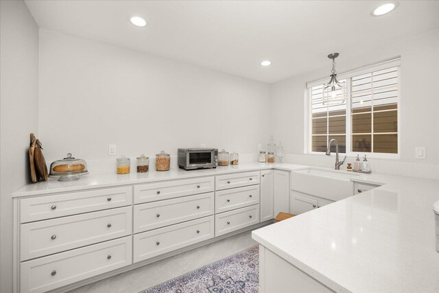 4620 E 43rd Ave, Spokane, WA 99223 - kitchen with light countertops, white cabinets, recessed lighting, and decorative light fixtures