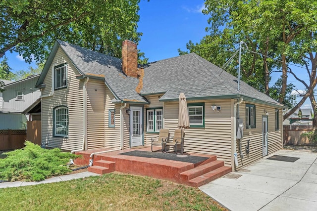 4217 E 22nd Ave, Spokane, WA 99223 - view of front of home with a patio area, a shingled roof, and a chimney