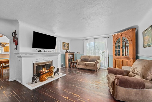 4217 E 22nd Ave, Spokane, WA 99223 - living area with a textured ceiling, wood-type flooring, and a glass covered fireplace