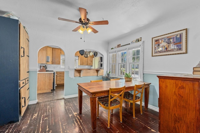 4217 E 22nd Ave, Spokane, WA 99223 - dining room featuring dark wood-style flooring, arched walkways, and ceiling fan