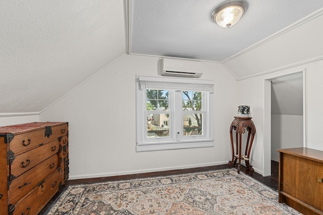 4217 E 22nd Ave, Spokane, WA 99223 - additional living space featuring an AC wall unit, a textured ceiling, lofted ceiling, and wood finished floors
