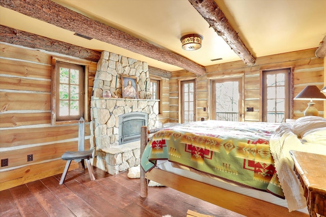 4629 Mix Way, Loon Lake, WA 99148 - bedroom featuring wood-type flooring, wooden walls, beamed ceiling, and a fireplace