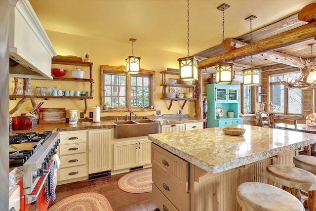 4629 Mix Way, Loon Lake, WA 99148 - kitchen featuring open shelves, stainless steel range, dark wood finished floors, a center island, and hanging light fixtures