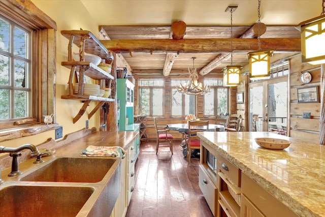 4629 Mix Way, Loon Lake, WA 99148 - kitchen with wood-type flooring, beam ceiling, hanging light fixtures, light stone counters, and french doors