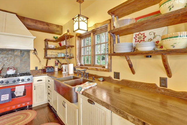 4629 Mix Way, Loon Lake, WA 99148 - kitchen featuring stainless steel gas range oven, custom exhaust hood, open shelves, backsplash, and hanging light fixtures
