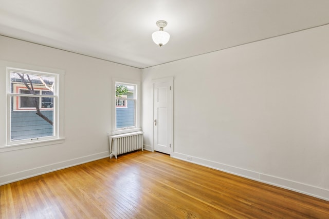 1107 W 19th Ave, Spokane, WA 99203 - unfurnished room with radiator, light wood-type flooring, and plenty of natural light