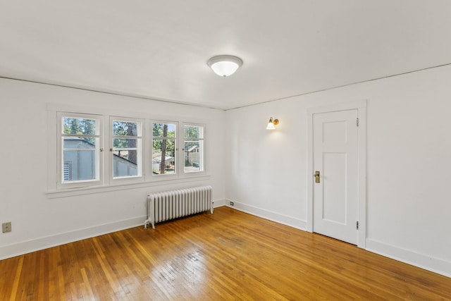 1107 W 19th Ave, Spokane, WA 99203 - empty room with radiator heating unit and light wood-type flooring