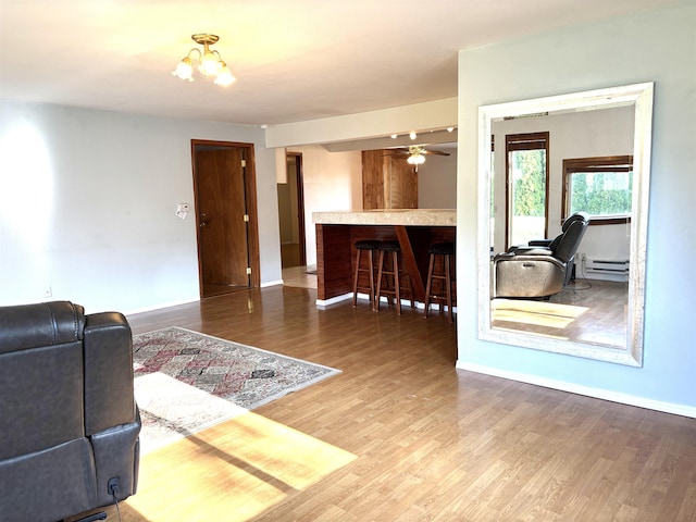 8602 E E Harrington Ave, Spokane Valley, WA 99212 - living area featuring wood finished floors, a chandelier, and a baseboard heating unit