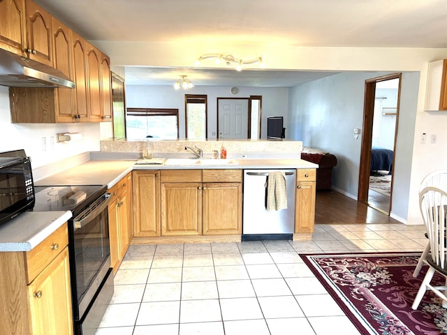 8602 E E Harrington Ave, Spokane Valley, WA 99212 - kitchen with stainless steel appliances, under cabinet range hood, a peninsula, light countertops, and light tile patterned flooring