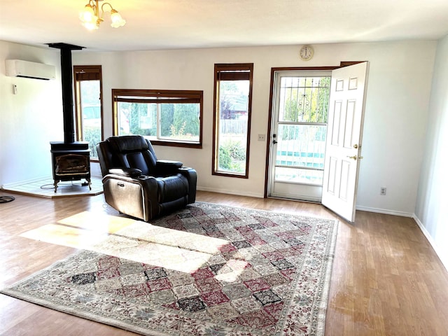 8602 E E Harrington Ave, Spokane Valley, WA 99212 - sitting room with a wall mounted air conditioner, a wood stove, and wood finished floors