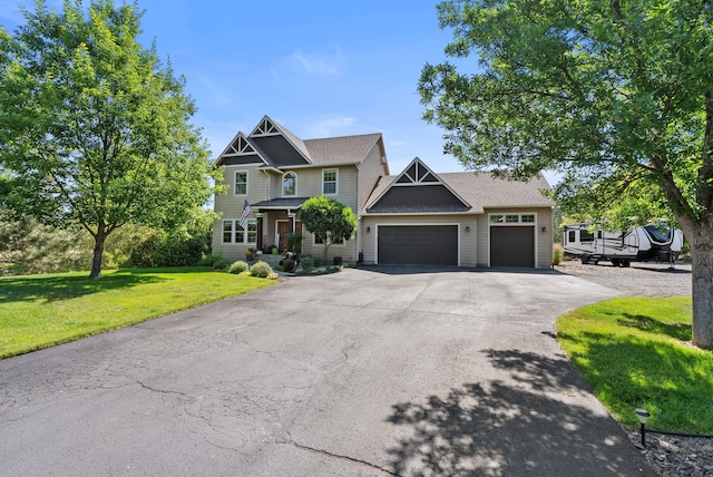5857 Little Sandy Loop Rd, Nine Mile Falls, WA 99026 - craftsman-style house featuring an attached garage, asphalt driveway, and a front lawn