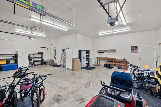 5857 Little Sandy Loop Rd, Nine Mile Falls, WA 99026 - garage featuring a garage door opener and freestanding refrigerator