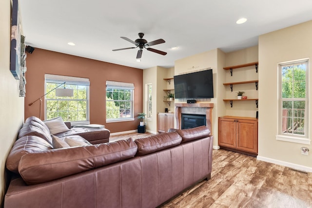 5857 Little Sandy Loop Rd, Nine Mile Falls, WA 99026 - living area featuring a glass covered fireplace, ceiling fan, light wood-type flooring, and recessed lighting