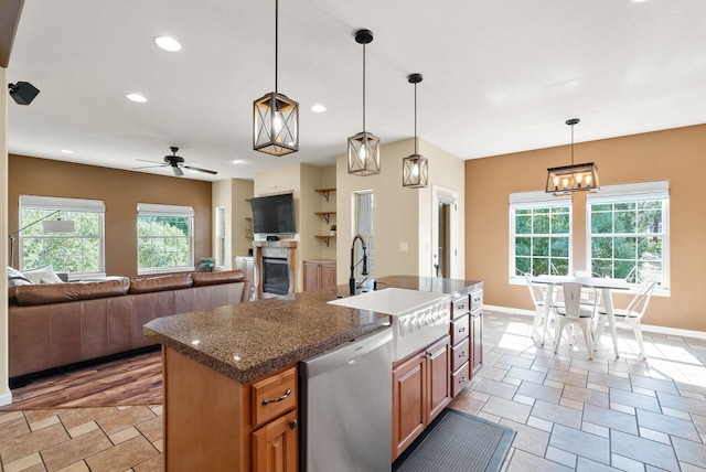 5857 Little Sandy Loop Rd, Nine Mile Falls, WA 99026 - kitchen featuring dishwasher, ceiling fan, open floor plan, decorative light fixtures, and brown cabinetry
